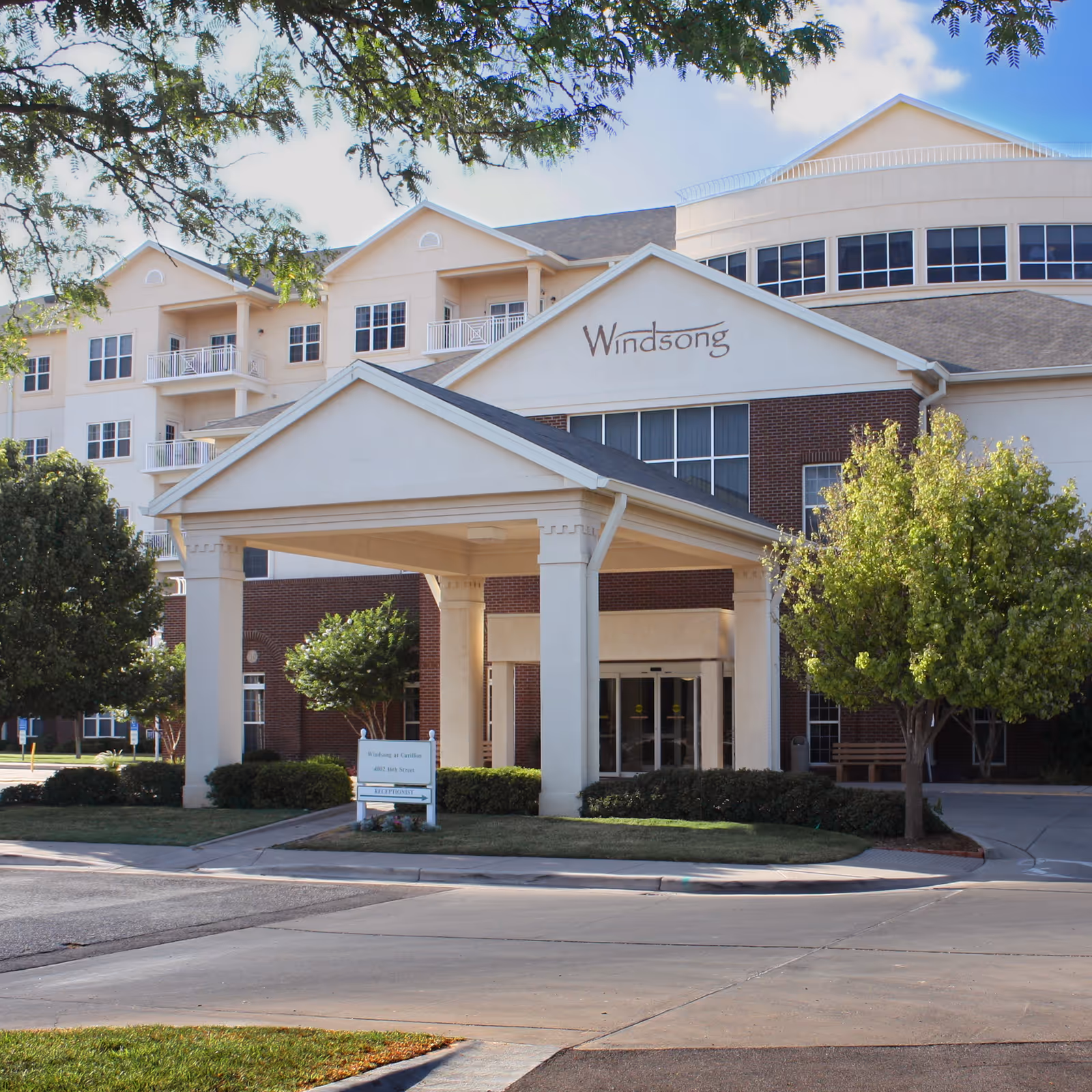 Exterior of Windsong senior living facility with a covered entrance canopy.