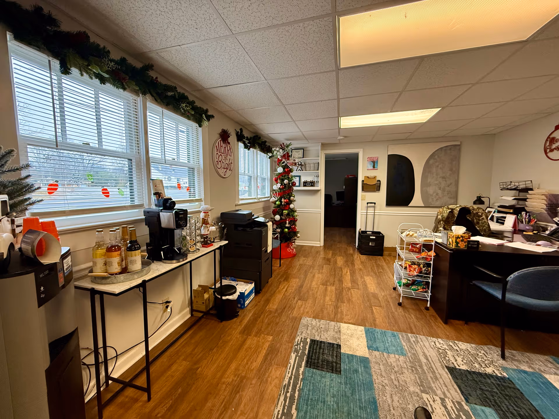 Indoor common area with coffee station, Christmas decorations, and a reception desk.