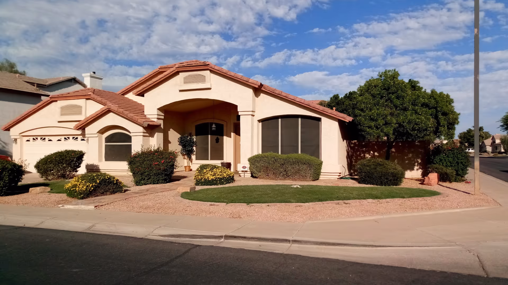Front exterior of a single-story assisted living facility with desert landscaping.
