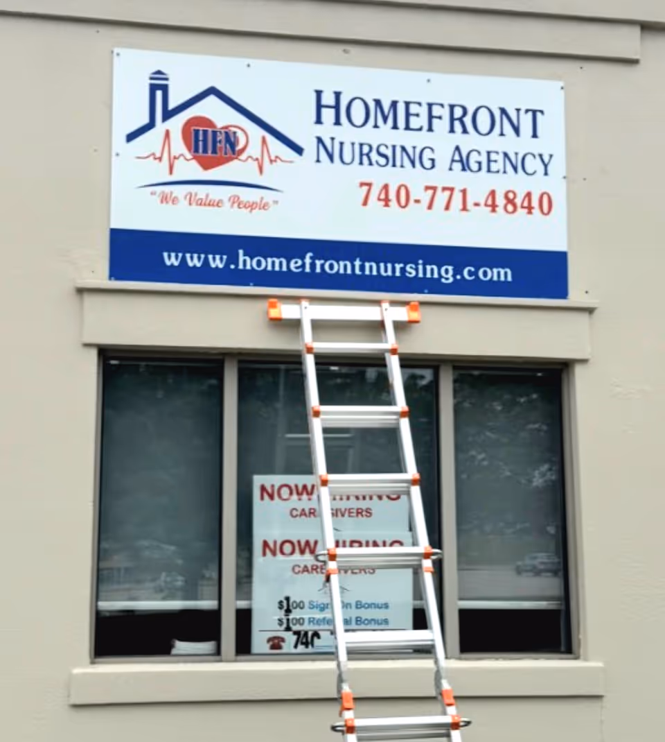 Front of a building with a Homefront Nursing Agency sign and a ladder