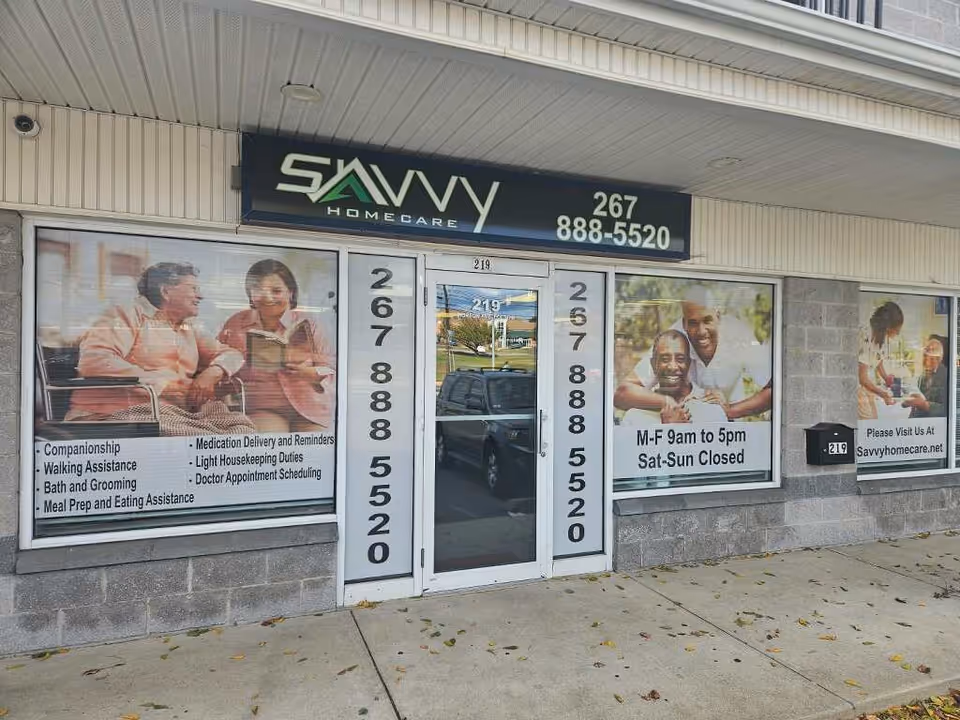 Savvy Home Care storefront with large window posters and a glass front door.