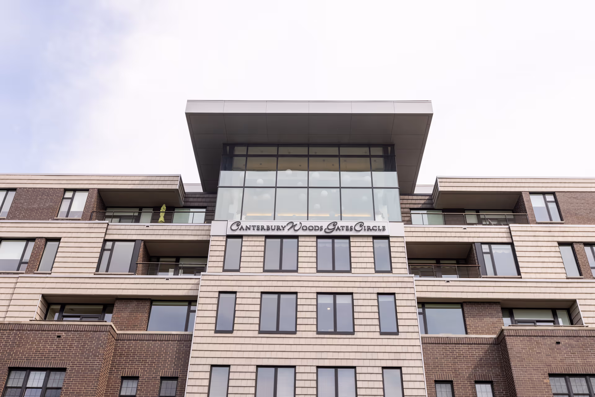 Exterior view of Canterbury Woods Gates Circle senior living building with balconies.