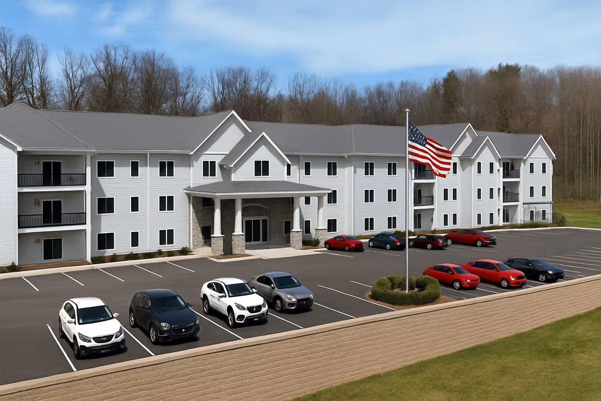 Exterior view of Emory Mills Senior Living building with parking and flag.