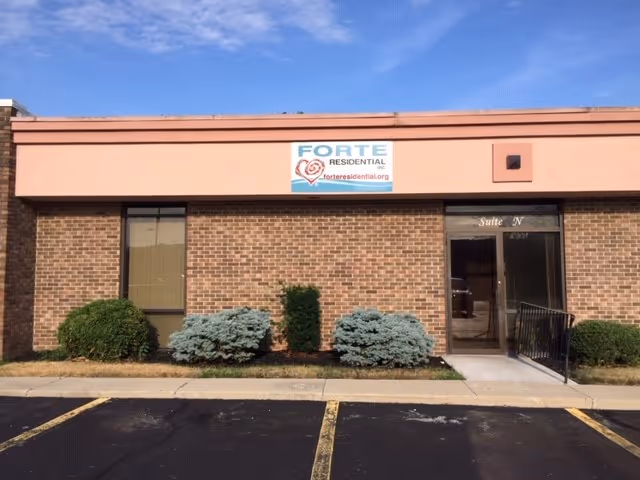 Brick-front Forte Residential building with Kokomo North Branch sign and landscaping.