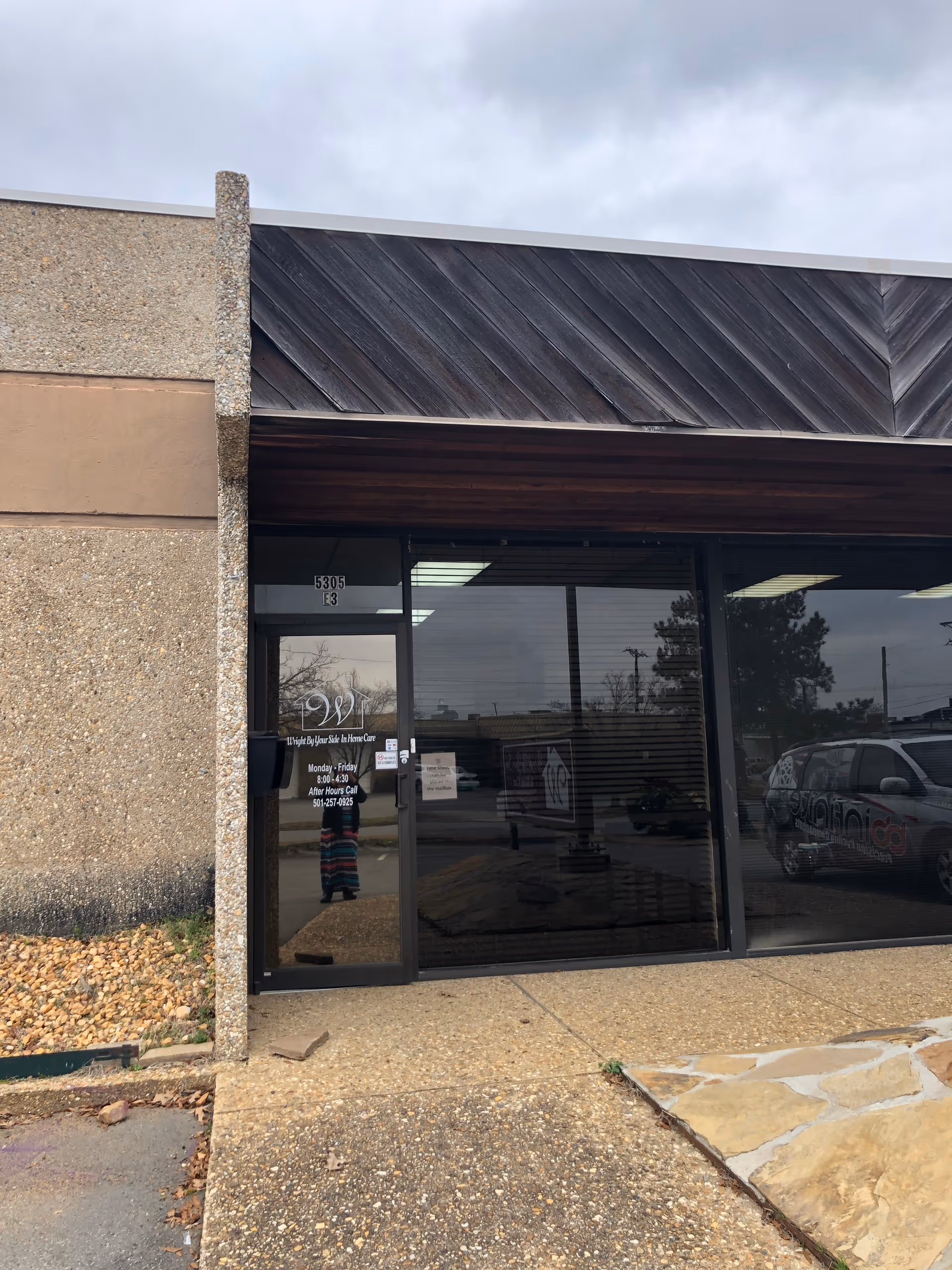 Front entrance of Wright By Your Side In Home Care with glass doors and signage.