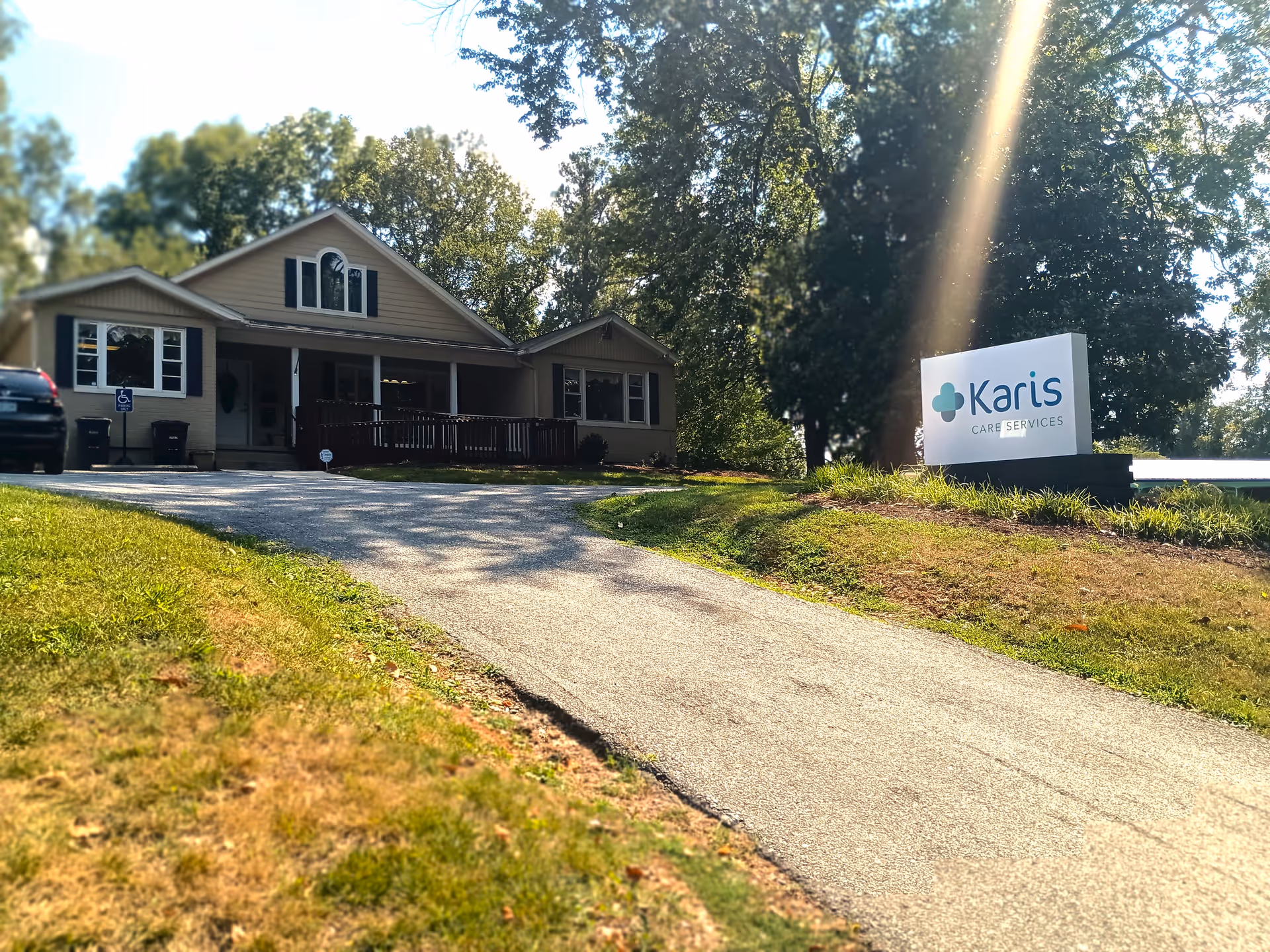 Exterior view of a single-story senior living facility with a Karis Care Services sign.