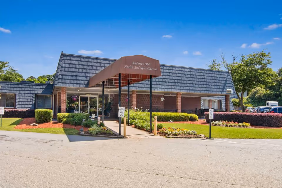 Front view of Anderson Mill Health and Rehabilitation Center with canopy entrance and landscaping.