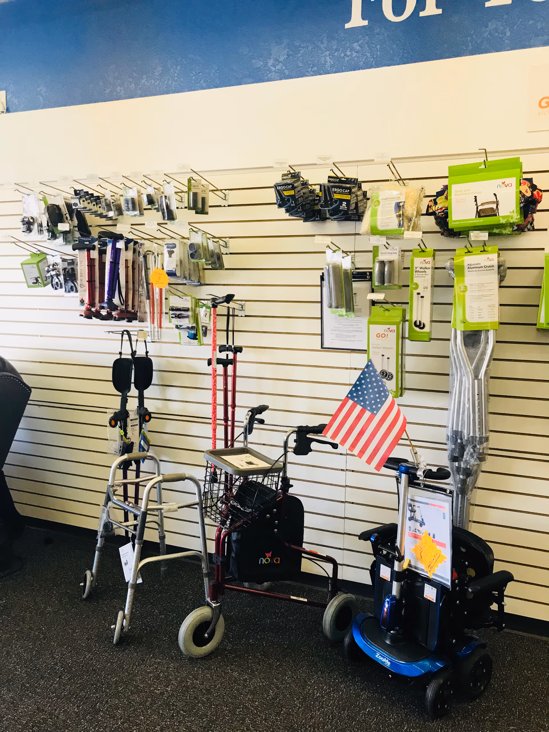 Interior showroom displaying mobility aids and accessories on wall-mounted slatwall.
