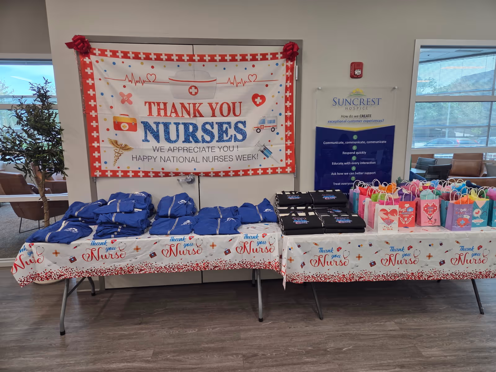 Indoor lobby with tables, a Nurses Week banner, and colorful gift bags for staff.