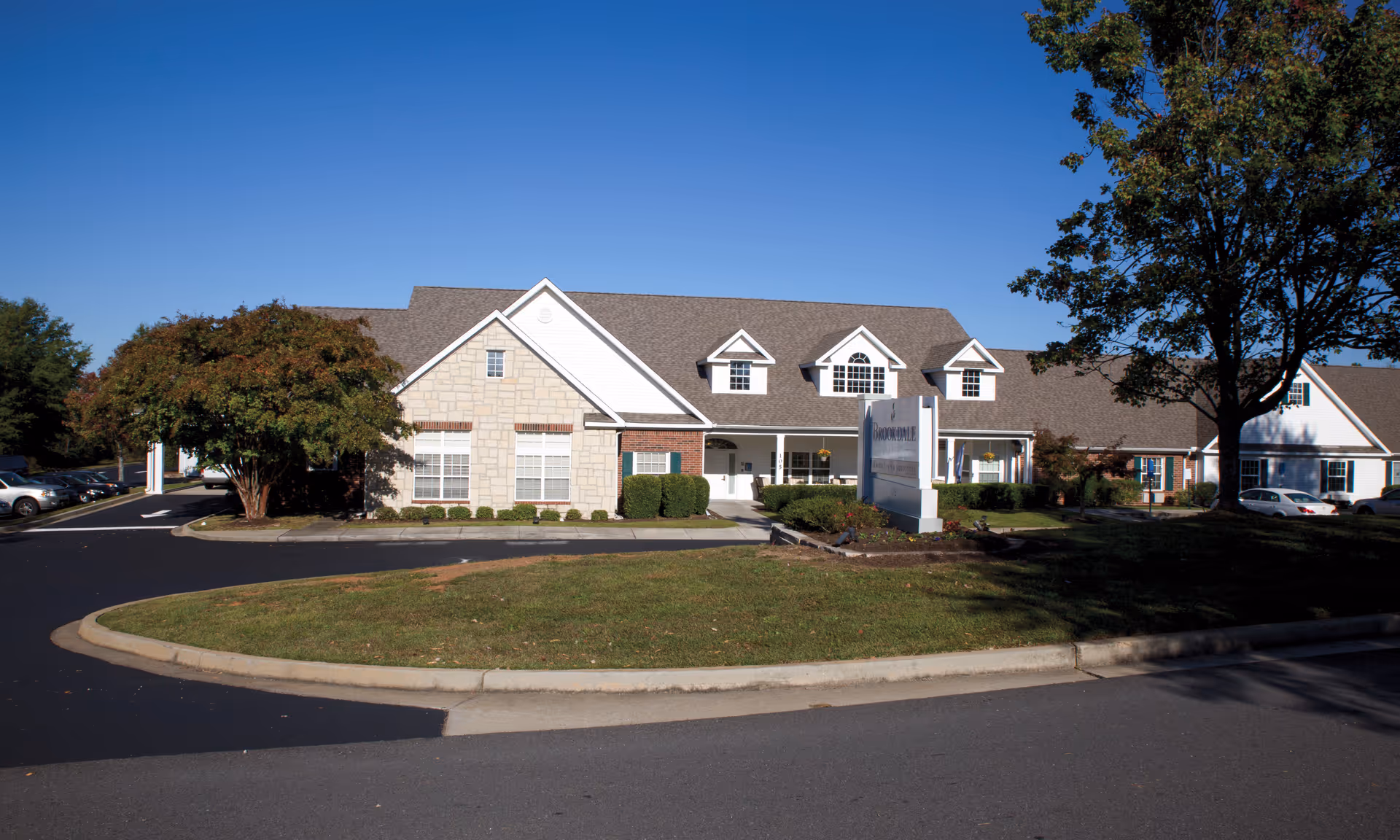 Exterior view of Brookdale North Augusta building with circular driveway and sign.