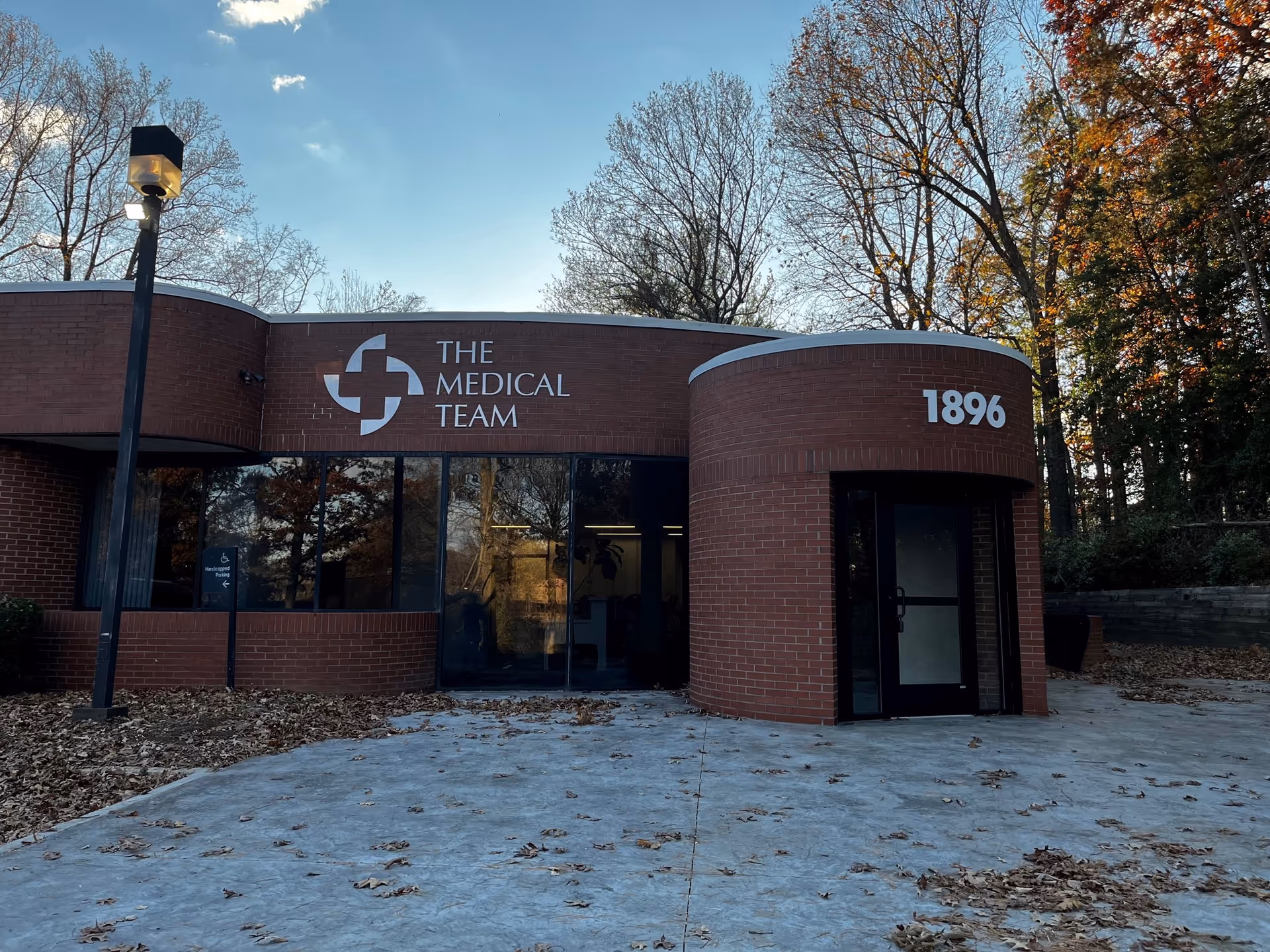 Brick medical facility front with a large sign reading 'The Medical Team' and 1896.