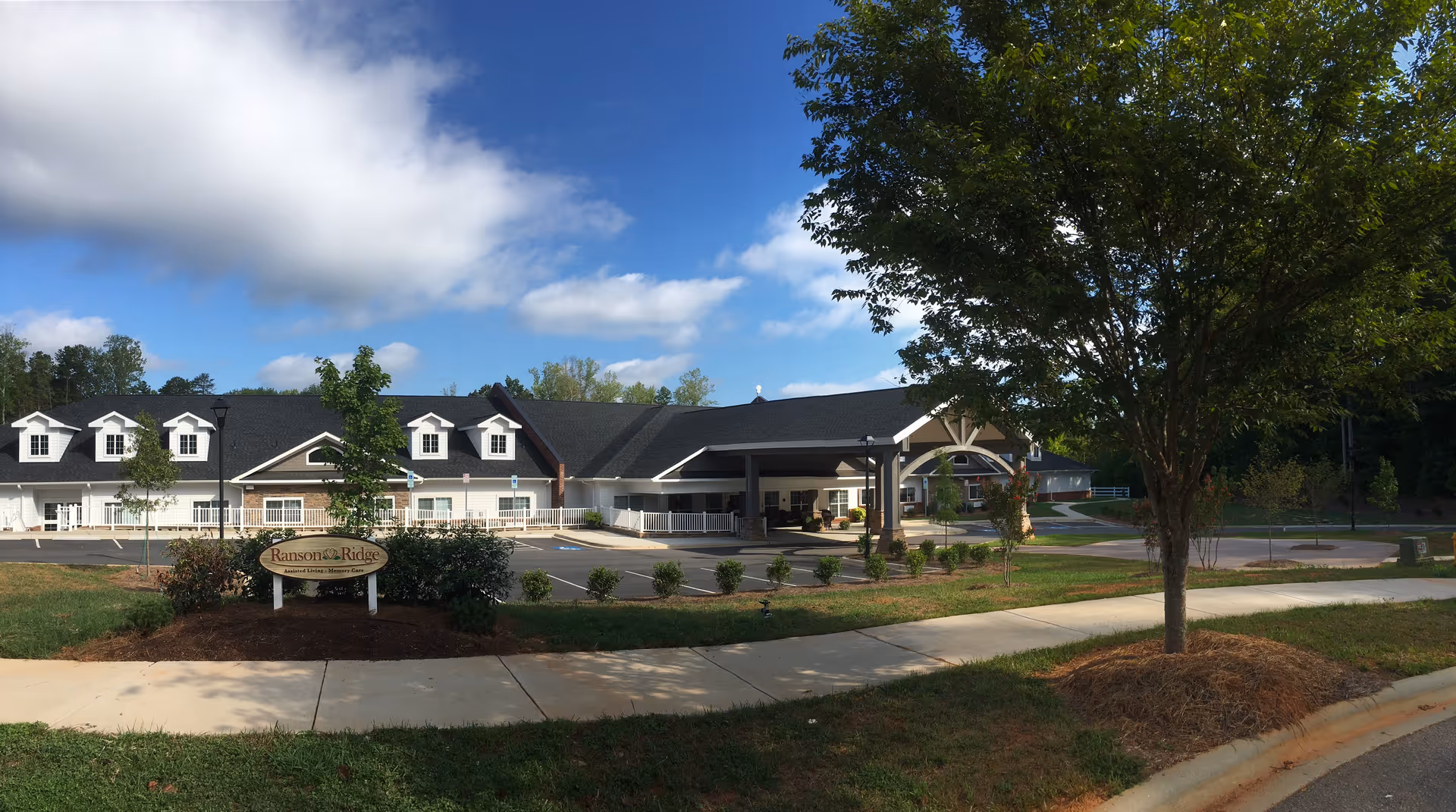 Exterior view of Ranson Ridge at the Villages of Mecklenburg with entrance and sign.