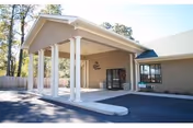 Exterior view of Arbor Springs Health and Rehab Center entrance with covered portico.