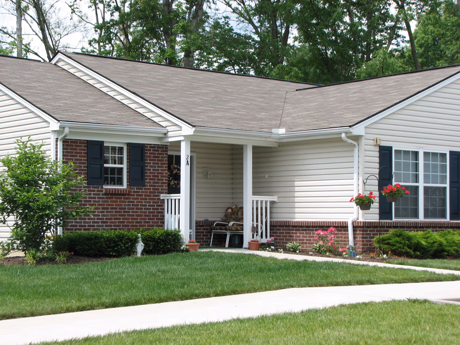 Front view of a single-story house-style senior living facility with a porch.