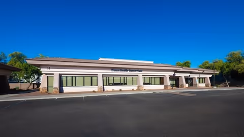 Front view of a single-story beige building with large windows and an HonorHealth Outpatient Therapy sign.