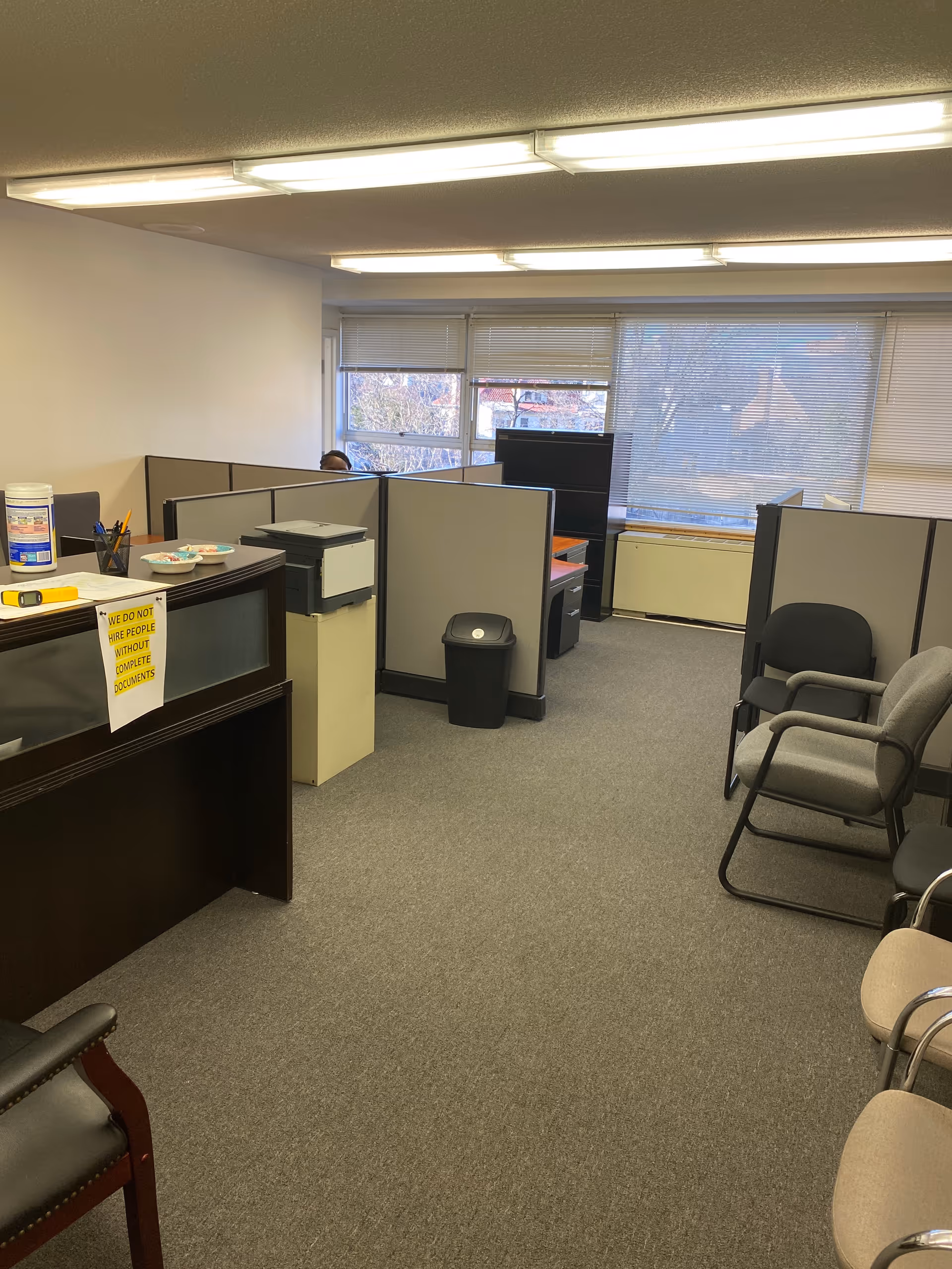 Interior office area with cubicles and chairs in a senior care facility.