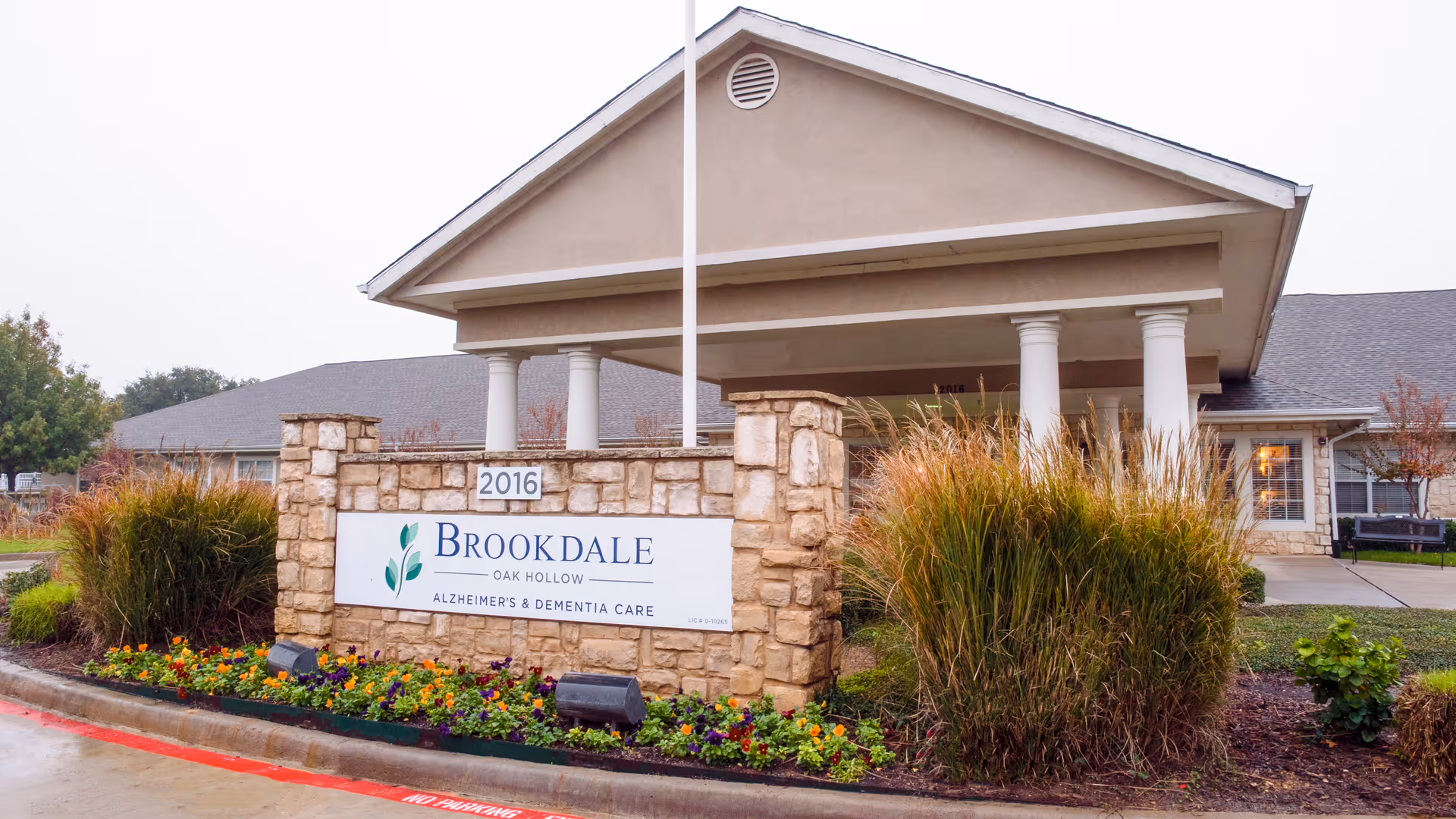 Brookdale Oak Hollow Alzheimer's care facility entrance with stone sign and landscaping