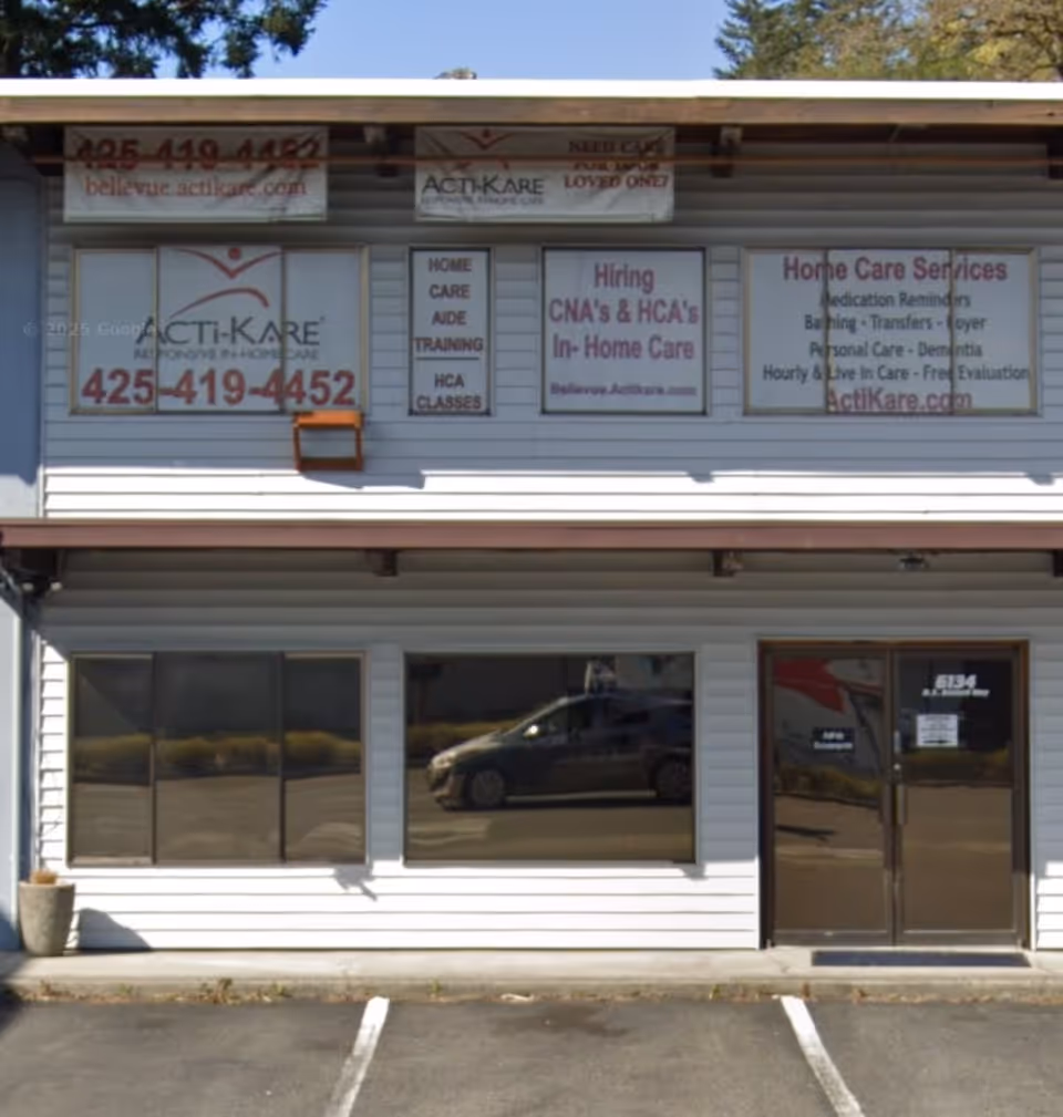 Storefront of Acti-Kare in-home care with signage and large windows.