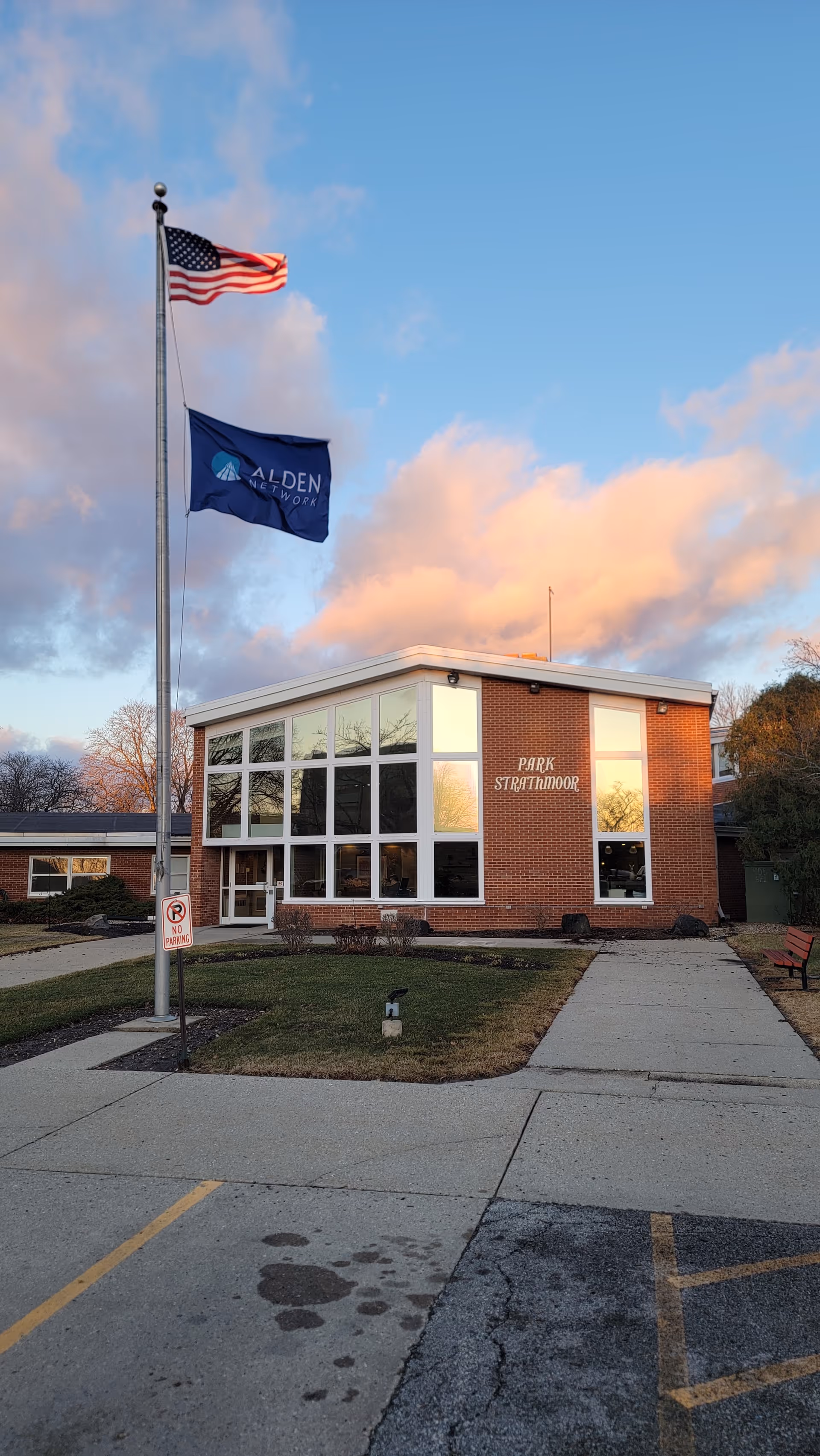 Alden Park Strathmoor exterior: brick building with large windows and flagpoles.
