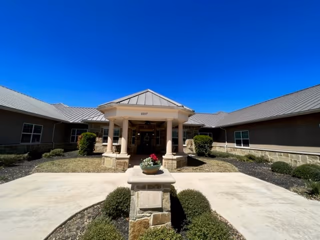 Entrance of Casa de Ramana Rehabilitation Center with columns, walkway, and manicured landscaping.
