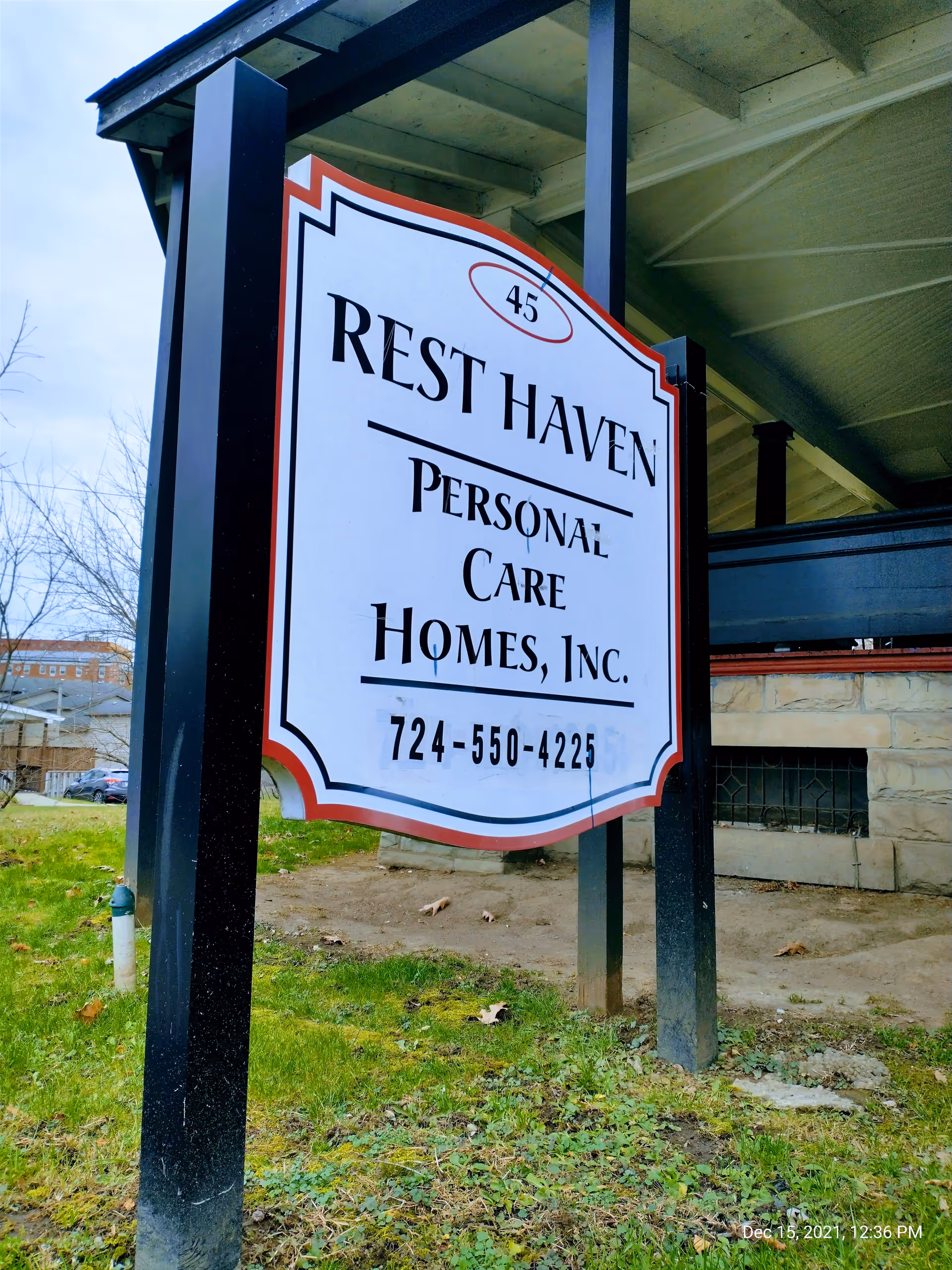 A large Rest Haven Personal Care Homes sign mounted on posts in front of a building.
