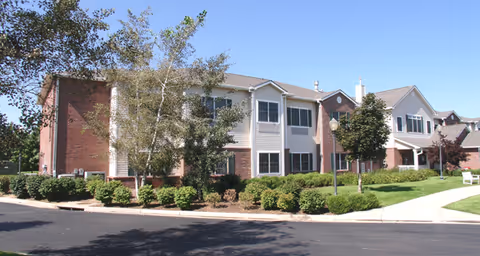 Exterior view of Cadence Aurora senior living building with landscaped front yard.