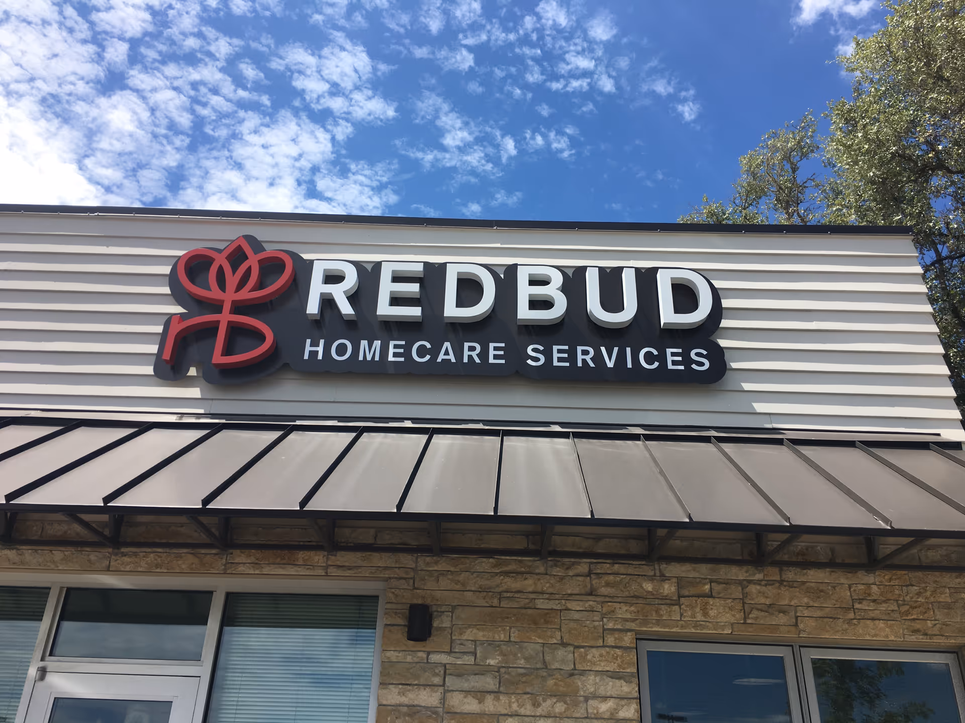 Front exterior of Redbud Homecare Services building with large sign