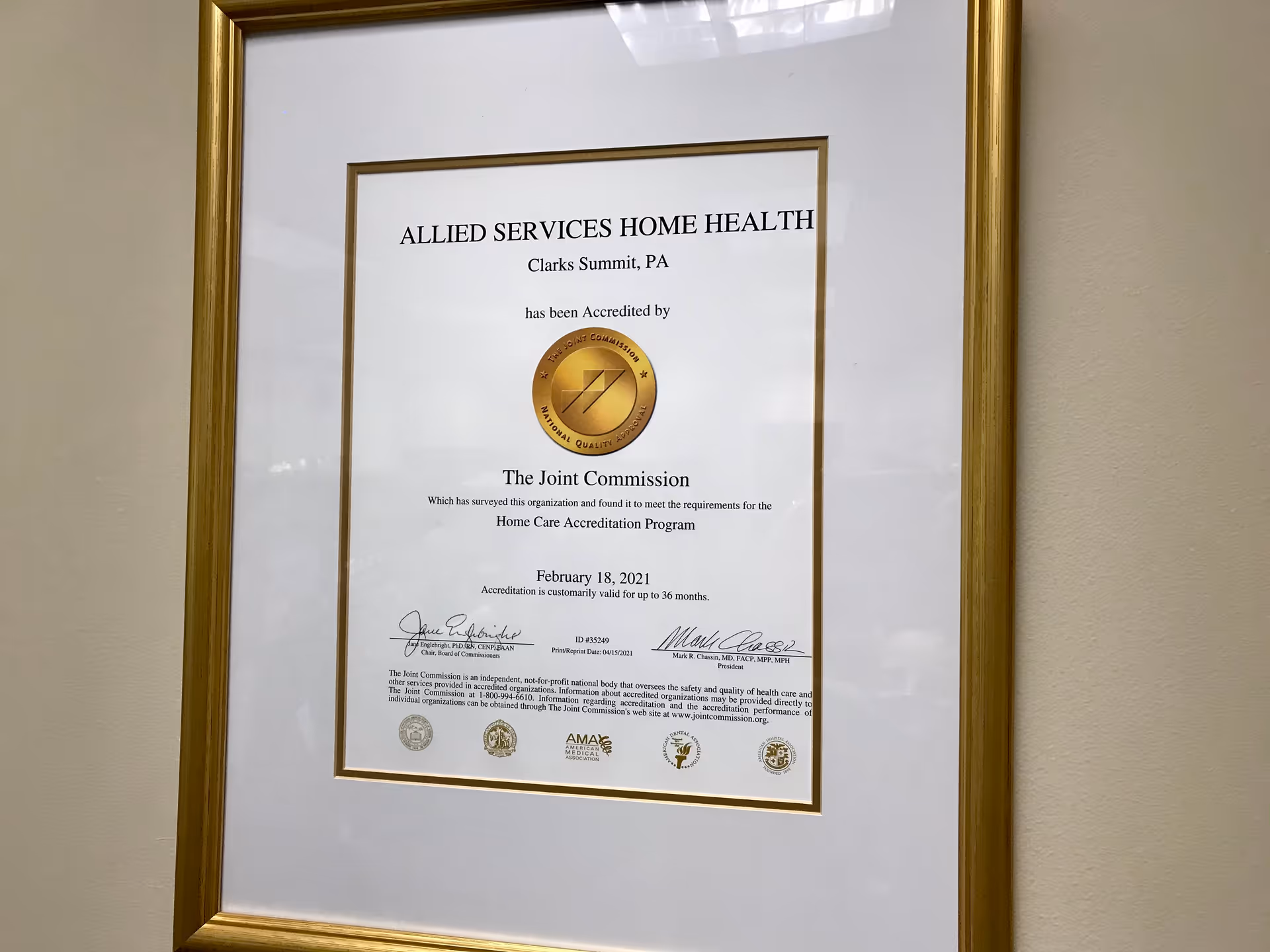 Framed certificate on a wall, reading Allied Services Home Health, hanging in a hallway.