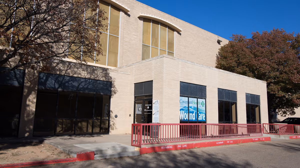 Exterior of Covenant Home Infusion building with red railing, large windows, and a wound care sign.