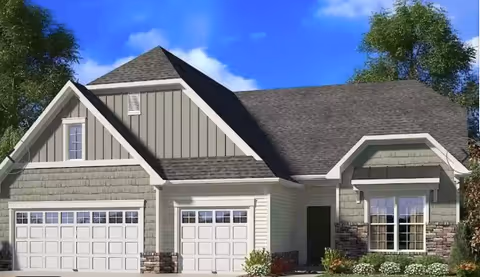 Front view of a modern beige-gray, single-story house with a three-car garage.