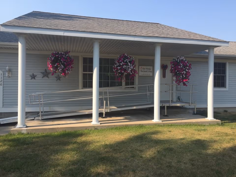 Front view of Our Family Assisted Living building with a covered porch and ramps.
