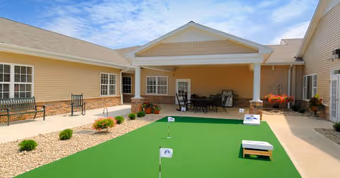 Outdoor courtyard at Prairie Lakes Health Campus featuring a green mini-golf area and seating.