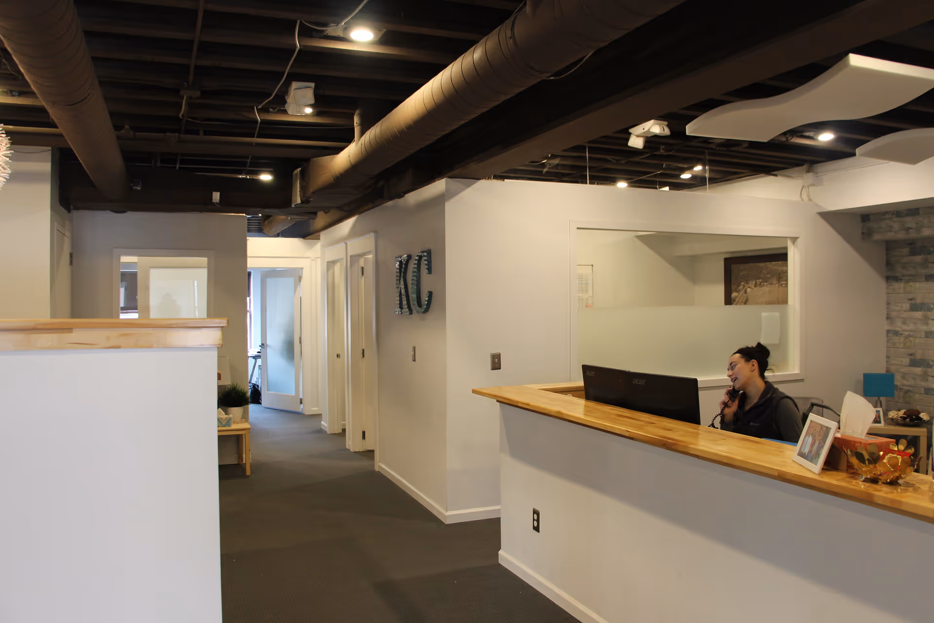 Reception desk with a receptionist on the phone inside Kennedy Care facility.