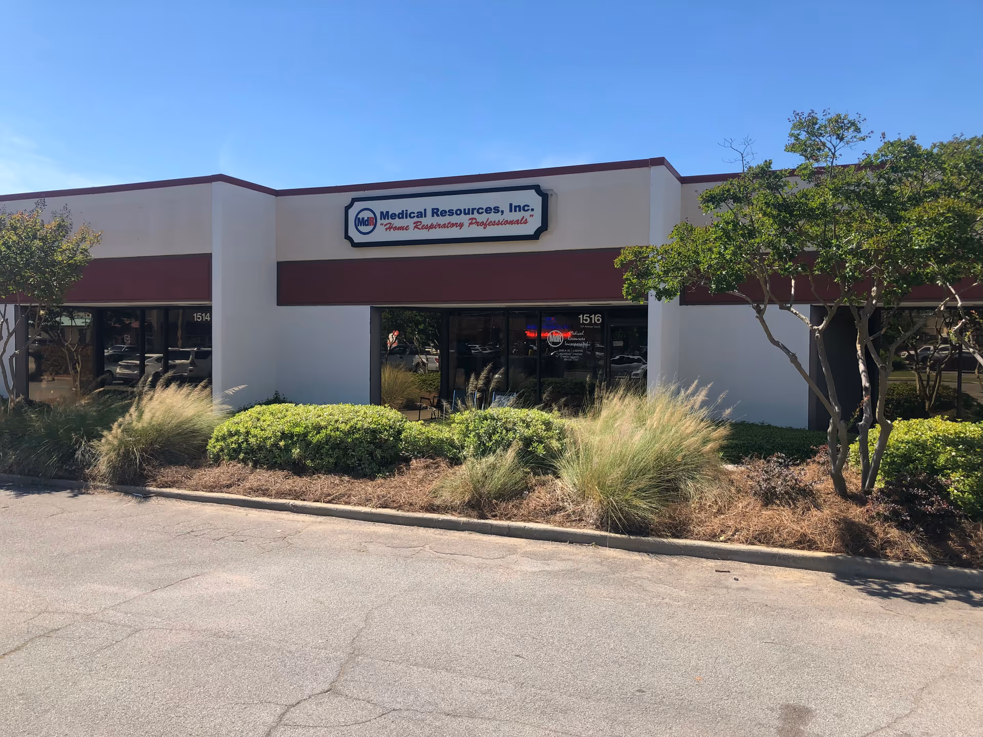 Exterior view of Medical Resources, Inc. storefront with sign and landscaped front.
