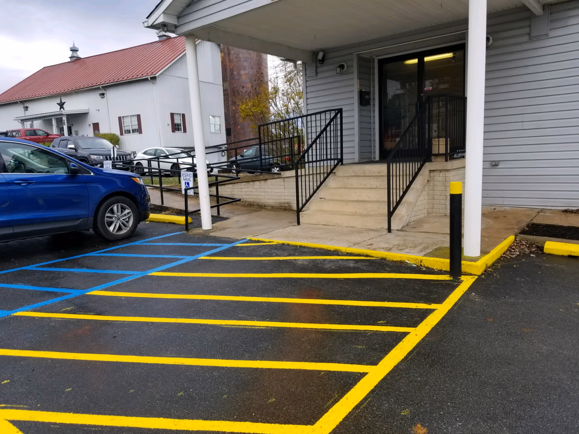 Front exterior of Ability Home Care, LLC with entrance, ramp, and parking.