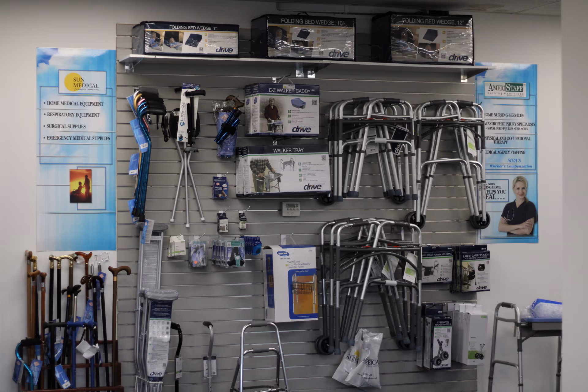 An interior display wall with walkers, canes, and medical equipment on shelves.