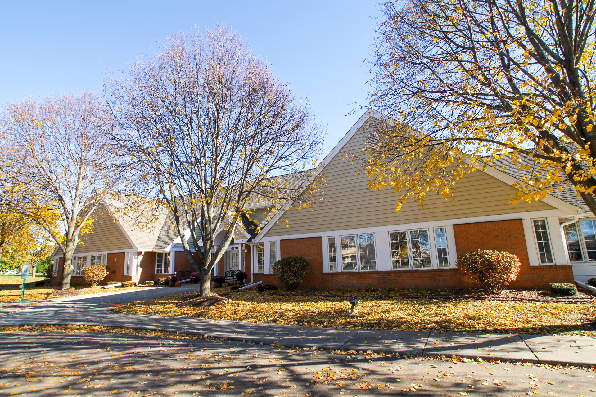 Senior living facility Brookdale Middleton Stonefield exterior with brick facade and autumn trees.