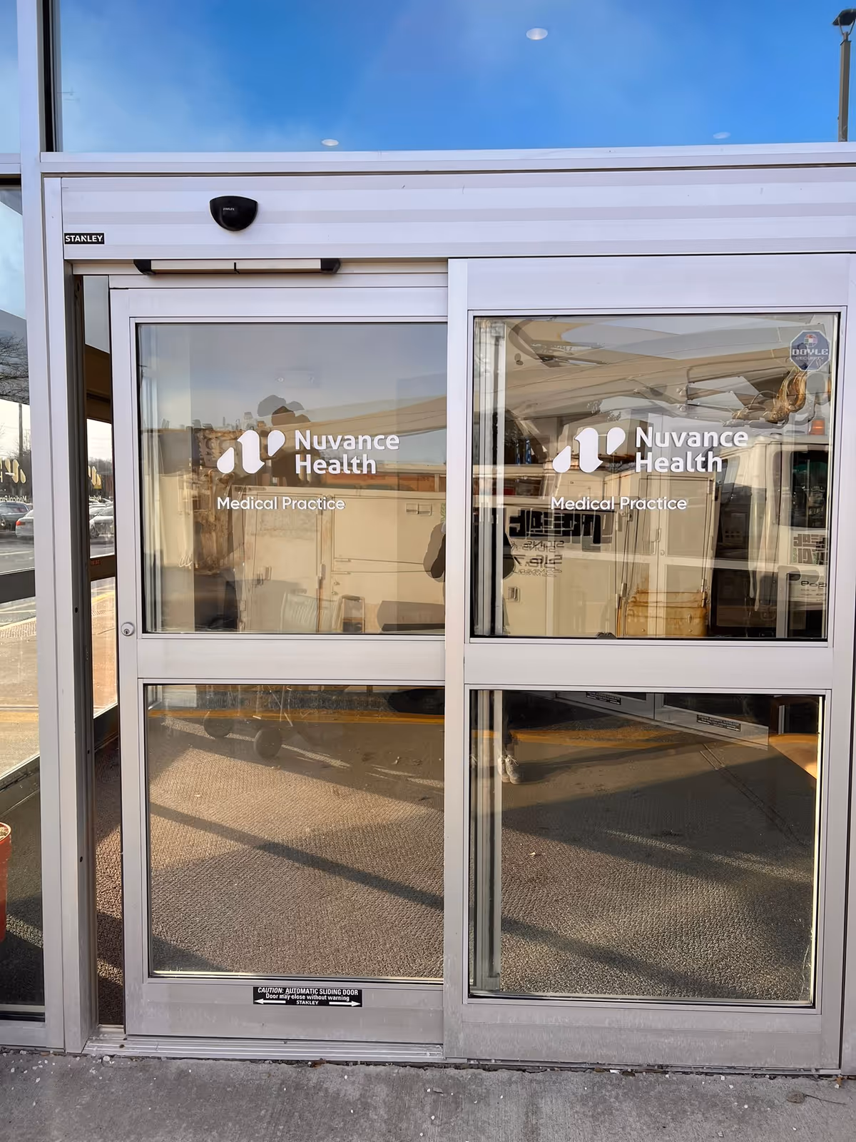Exterior glass doors display Nuvance Health Medical Practice signage.