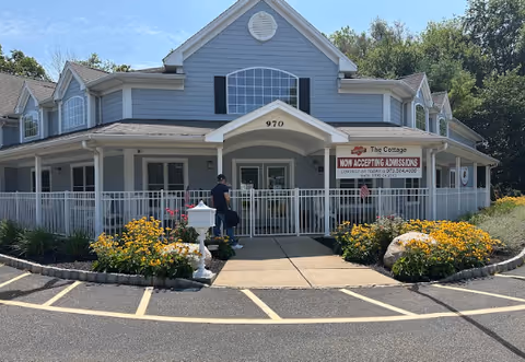 Front view of Merry Heart Memory Care LLC building with covered entrance and landscaping