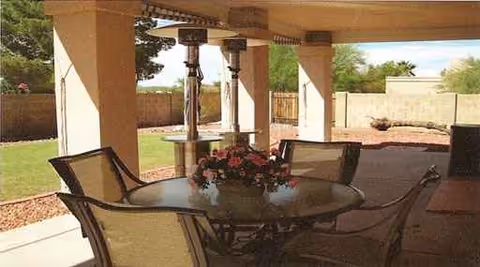 Outdoor covered patio at Best Care Home of Moon Valley with a round table and chairs.