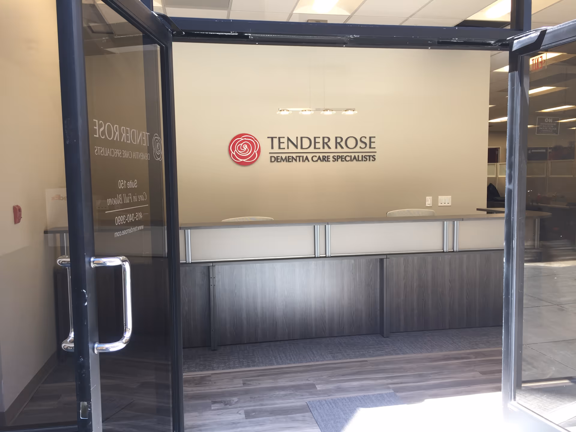 Reception desk inside a lobby with Tender Rose signage on the wall.