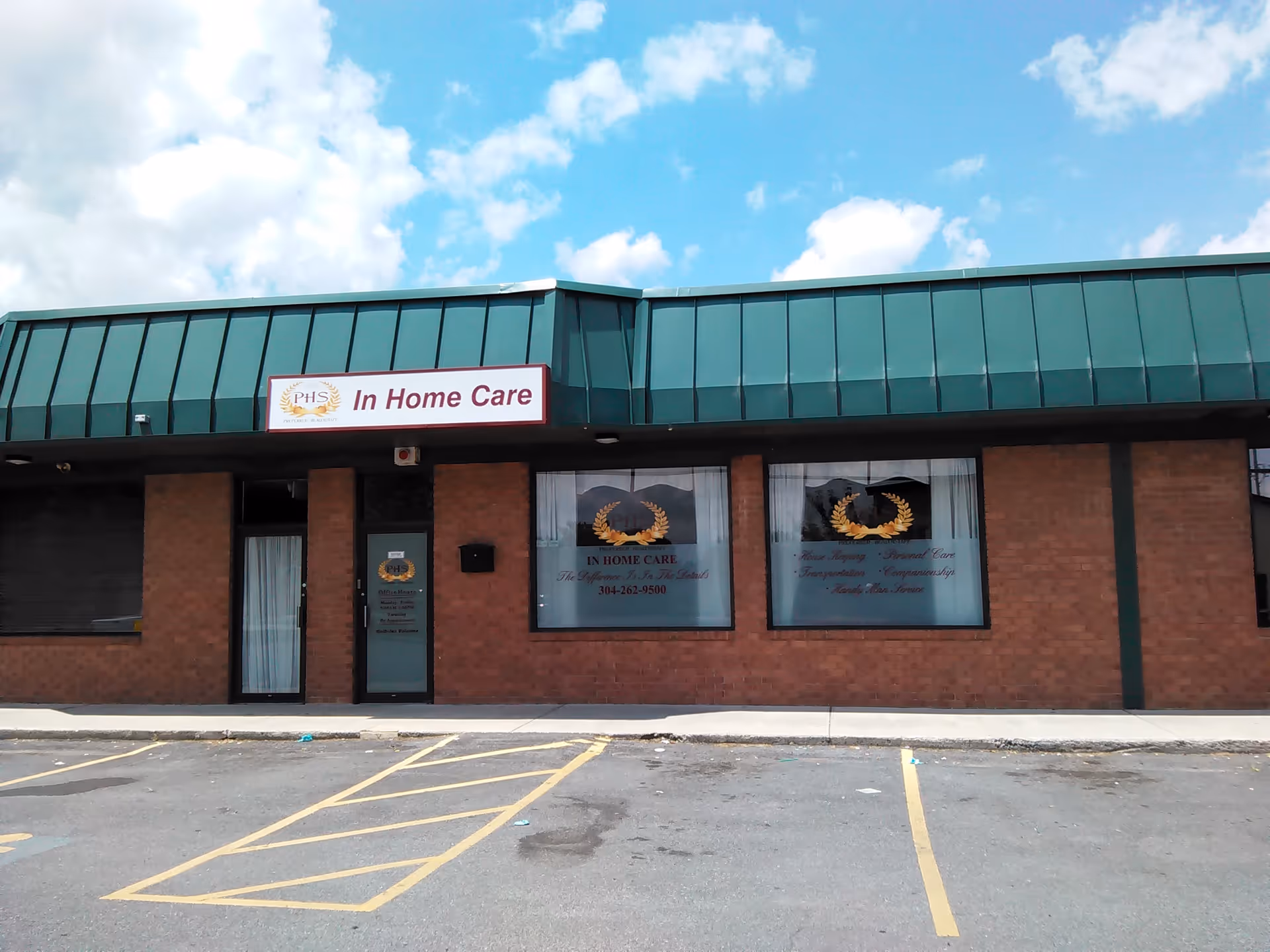 Brick storefront with a green metal awning and 'In Home Care' sign outside.
