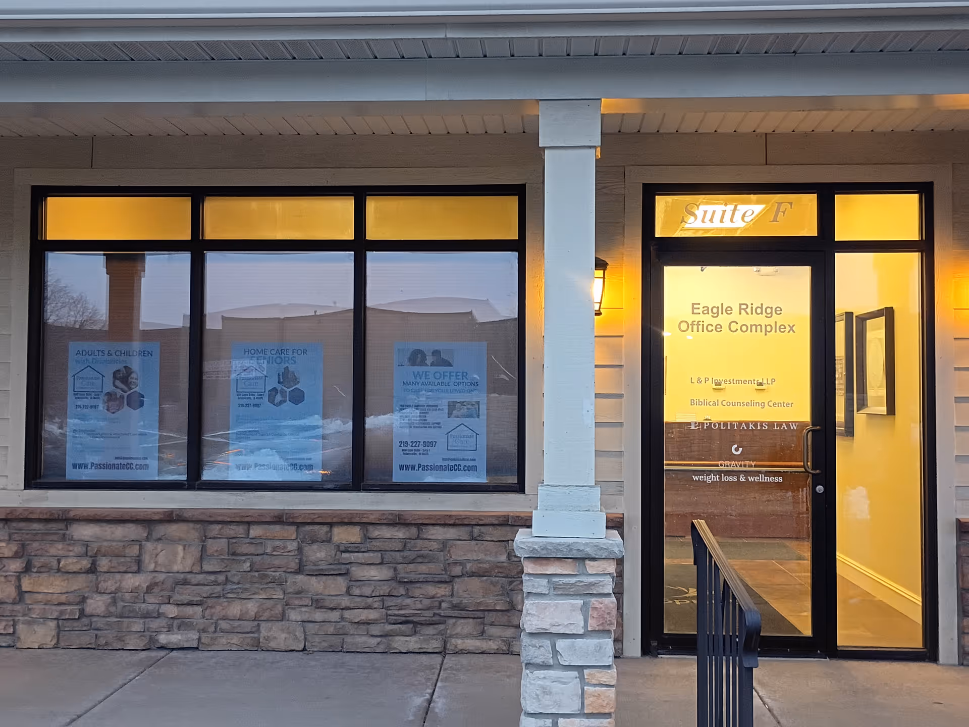Exterior of a building with large windows and a glass door labeled Suite F.