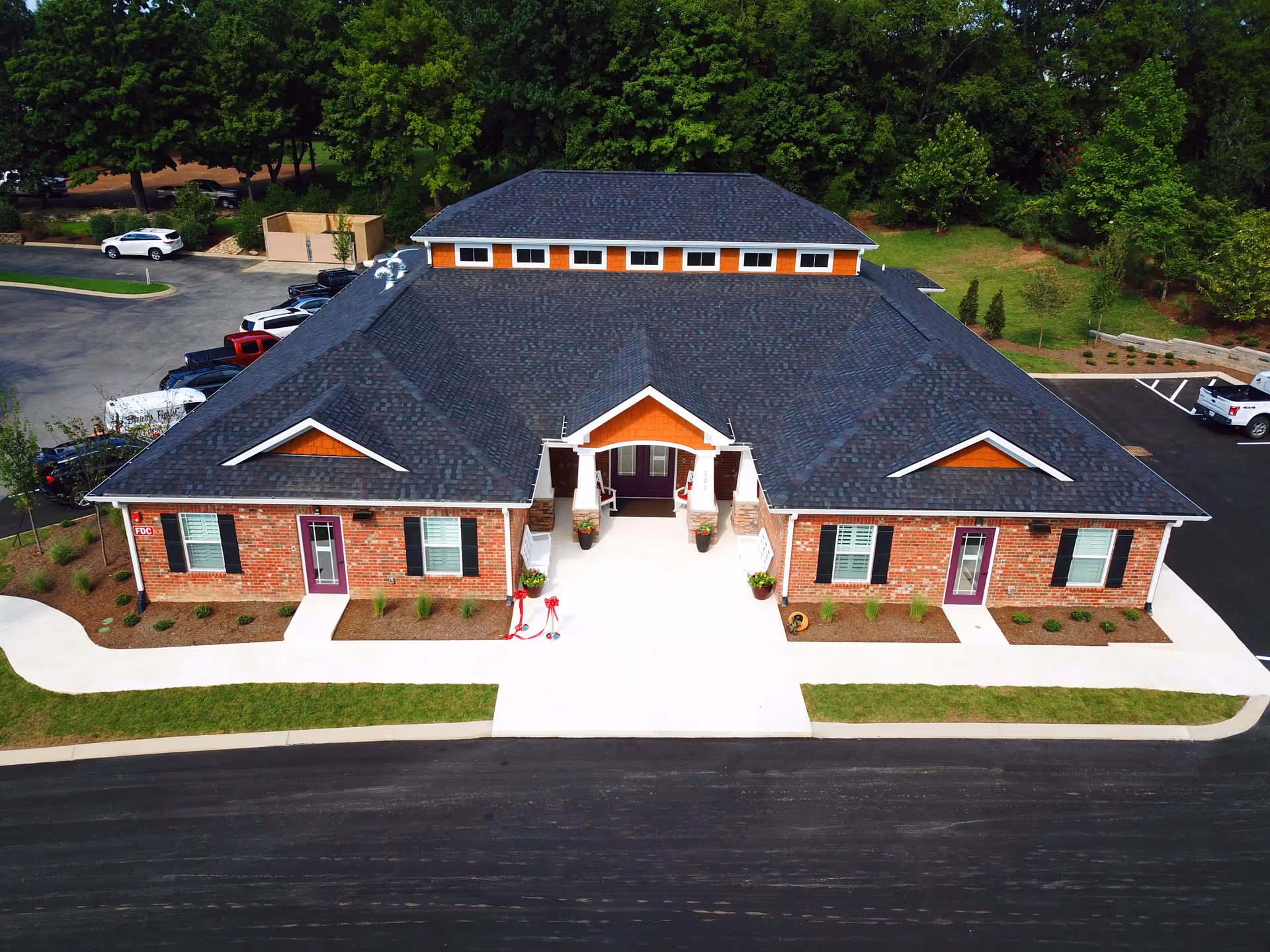A single-story brick Maple Cottage Memory Care facility with a dark roof and front entrance.