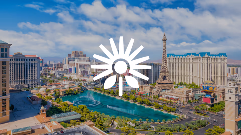 Aerial view of Las Vegas Strip with hotels, fountains, and a central watermark logo.