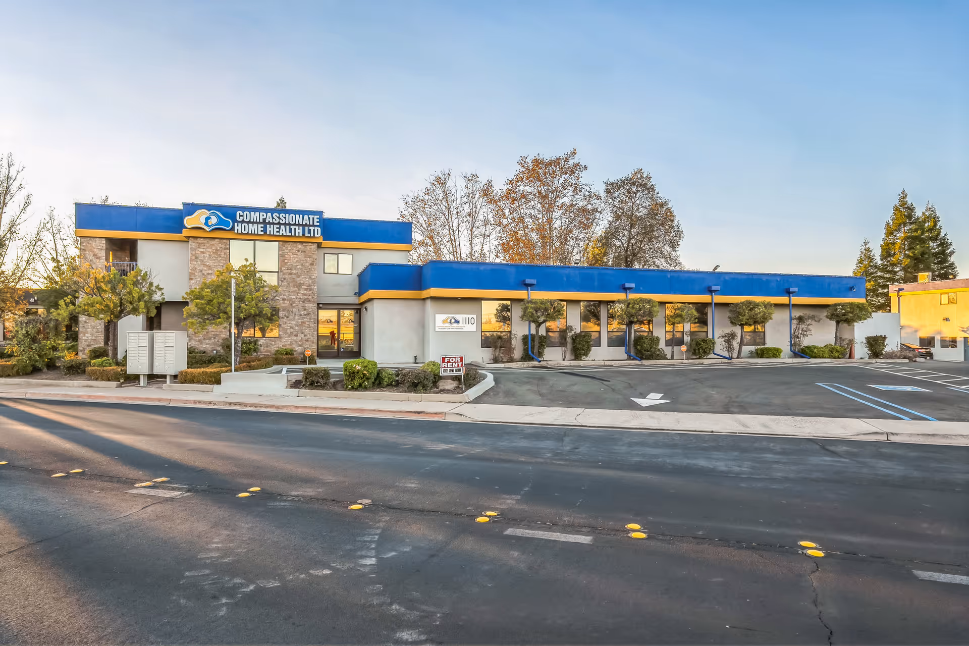 Front exterior of Compassionate Home Health Ltd facility with blue signage and parking lot.
