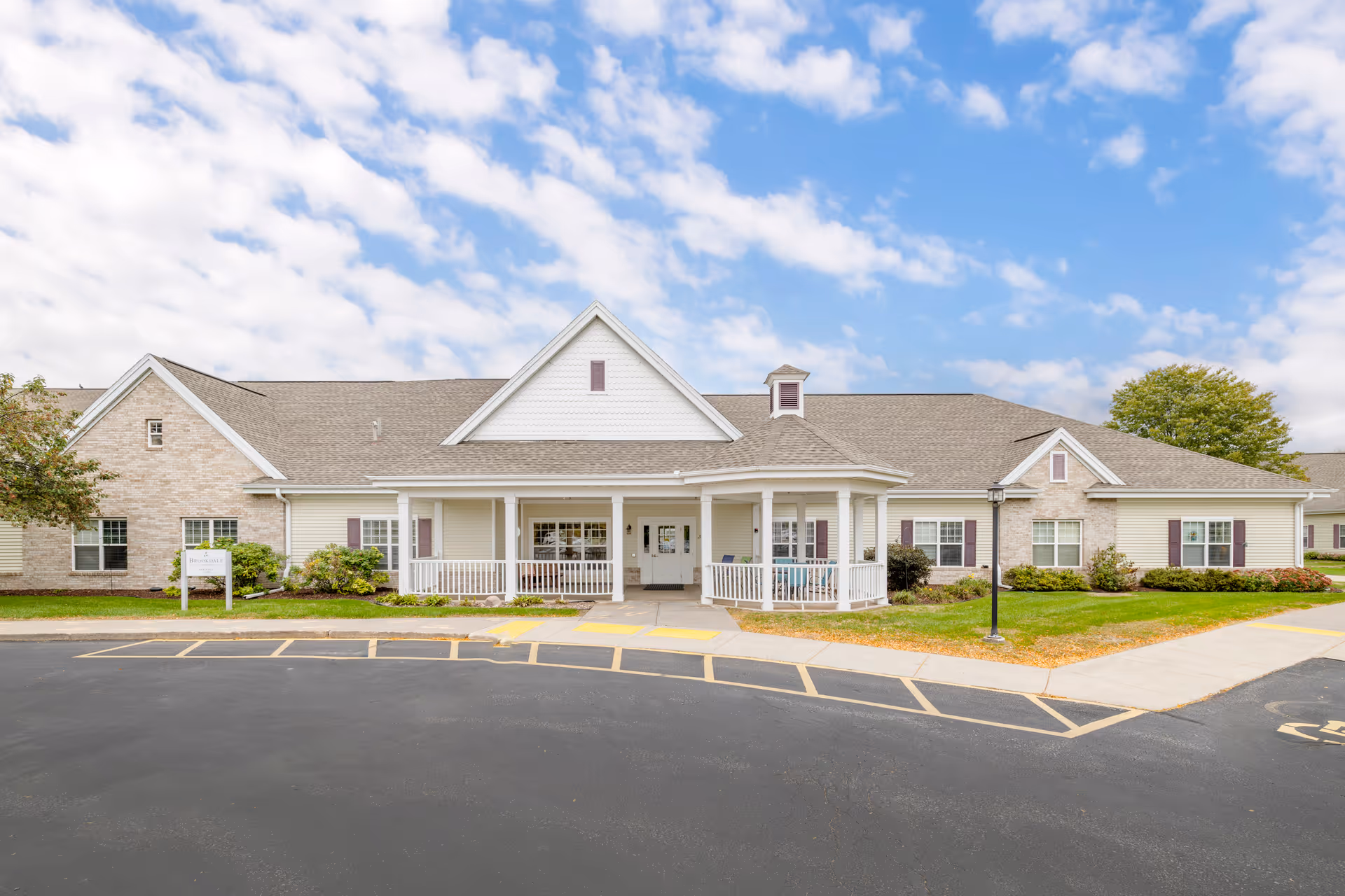 Single-story senior living facility with a covered entrance and manicured landscaping.