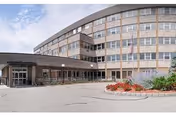 Curved, multi-story Sky View Rehabilitation and Health Care exterior with entrance.