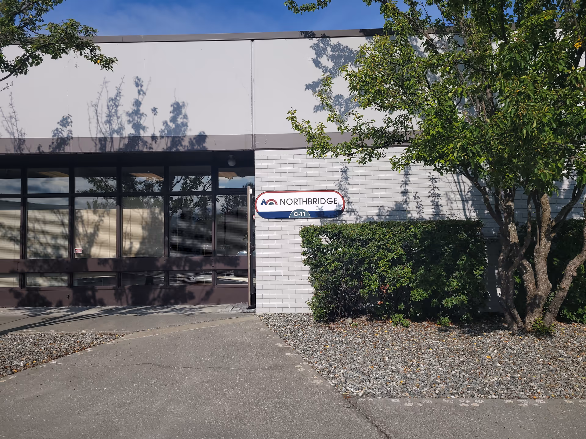 Front view of a Northbridge senior living facility with sign and trees