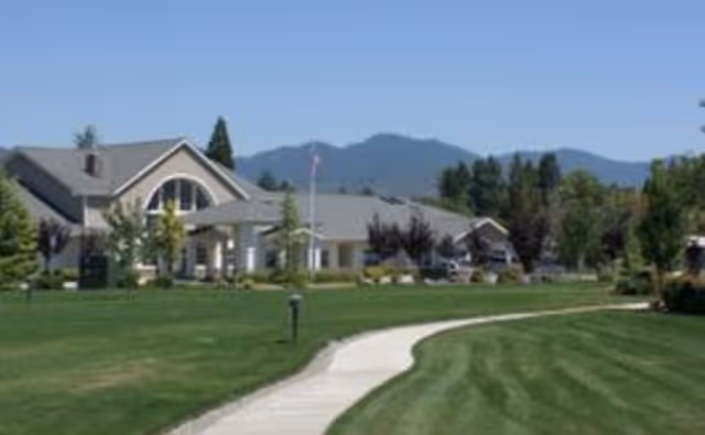 Exterior view of Bes House of Hope II with a curved sidewalk, manicured lawn, and trees.